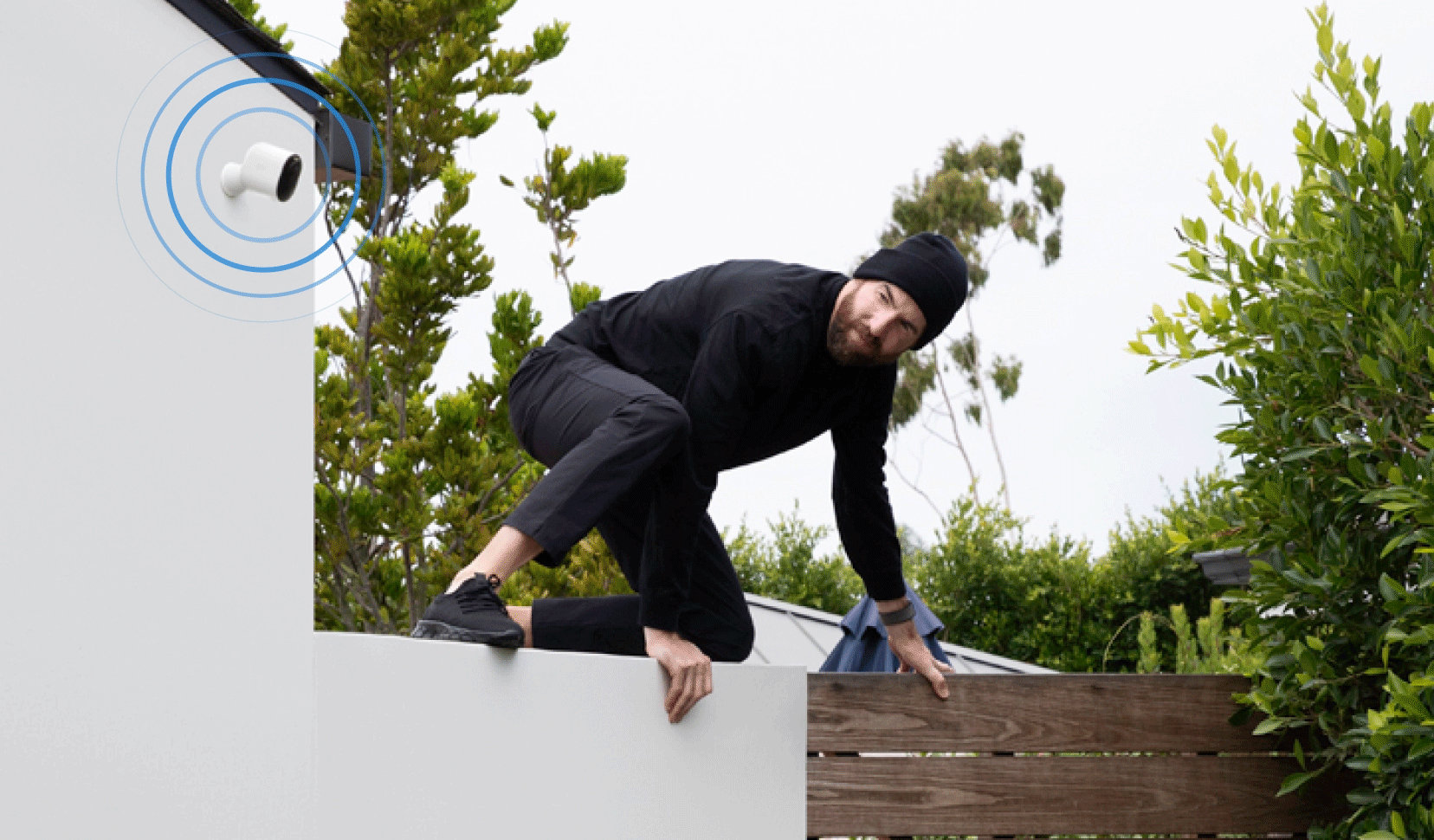 Arlo Pro 6 XL camera pulsating sirens at burglar jumping over house fence
